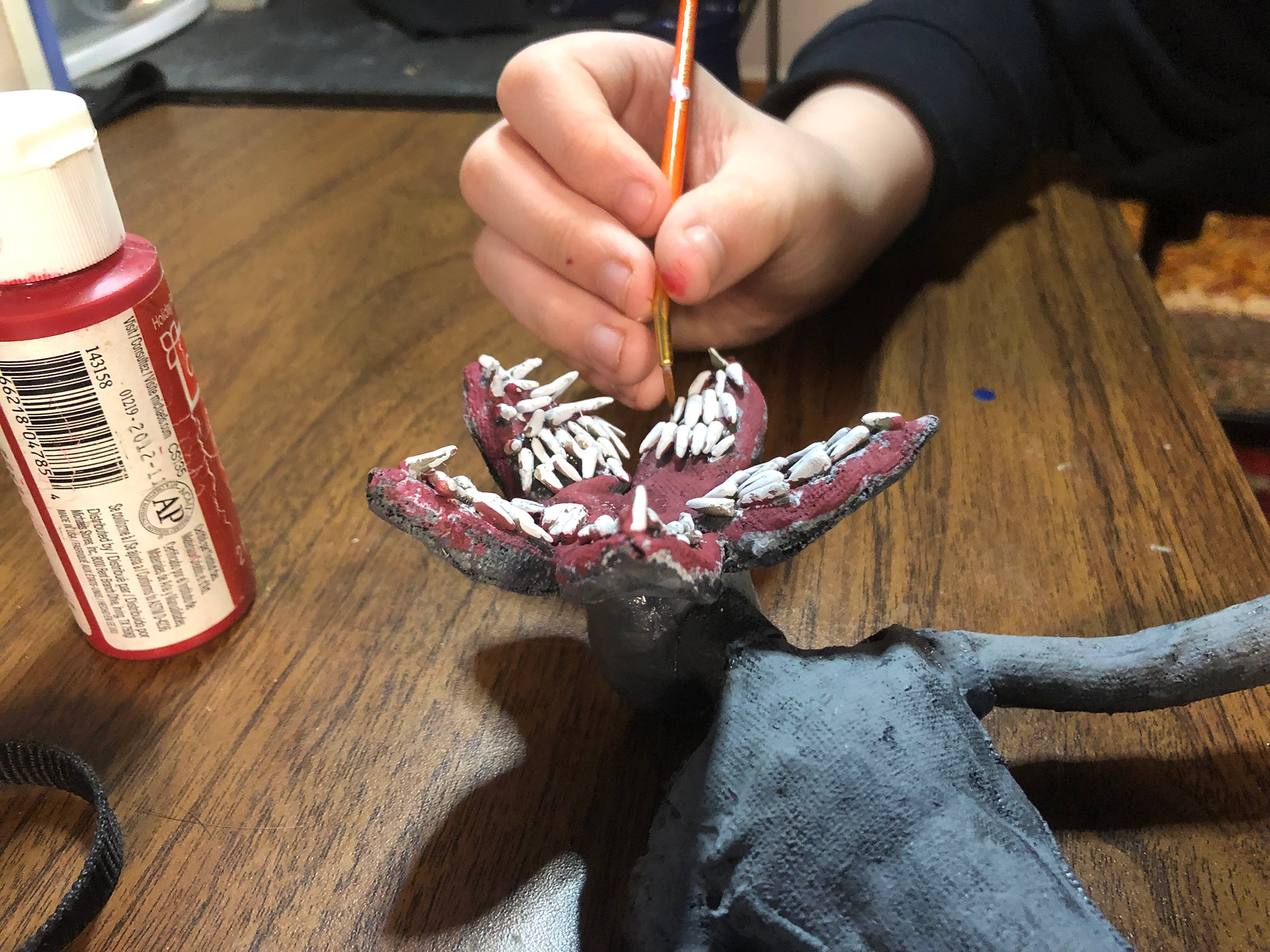 Animation student Ryder develops his Demogorgon puppet, a stop motion animation project created during the workshop by The Clayman Studio. The images captures the hands-on creative process of character design and animation production.