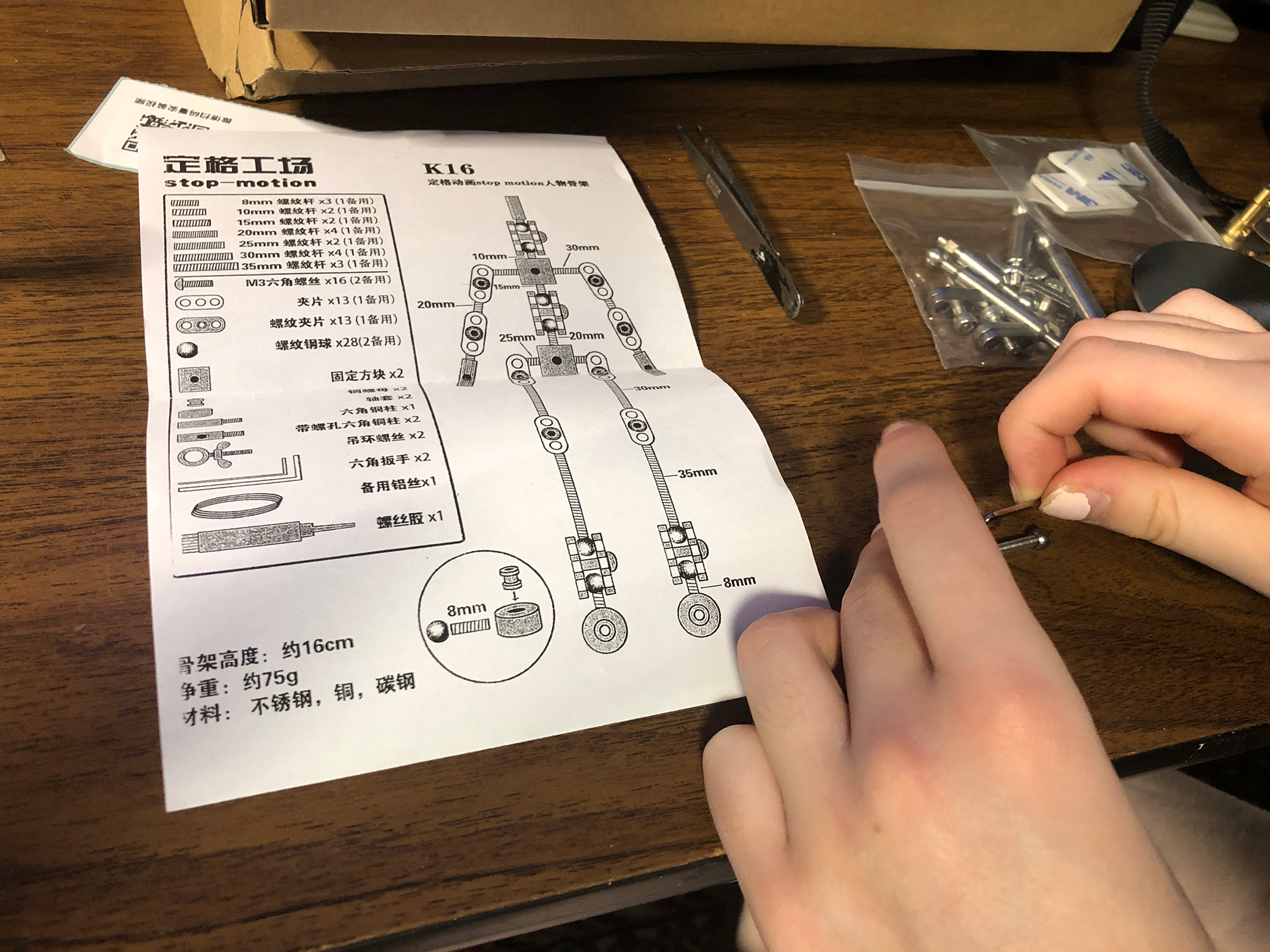 Animation student Marion assembling her new stop motion ball and socket armature project. Workshops by The Clayman Studio. The image captures the hands-on creative process of character design and animation production.