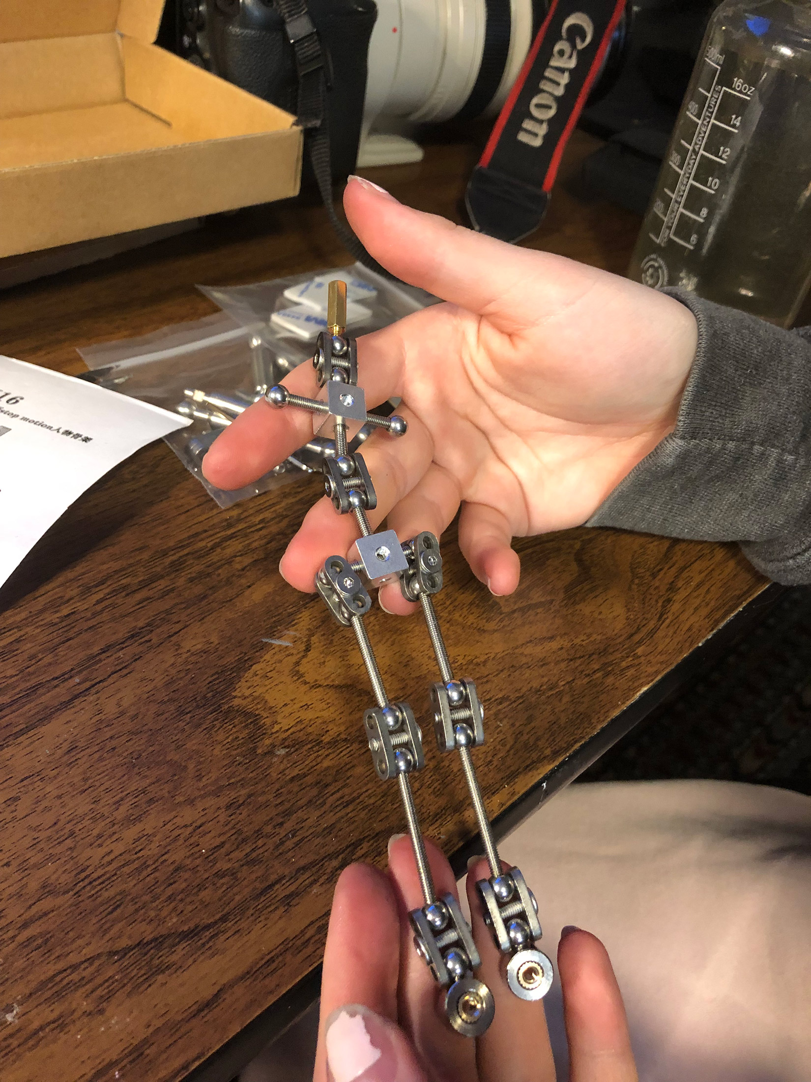 Animation student Marion assembling her new stop motion ball and socket armature project. Workshops by The Clayman Studio. The image captures the hands-on creative process of character design and animation production.