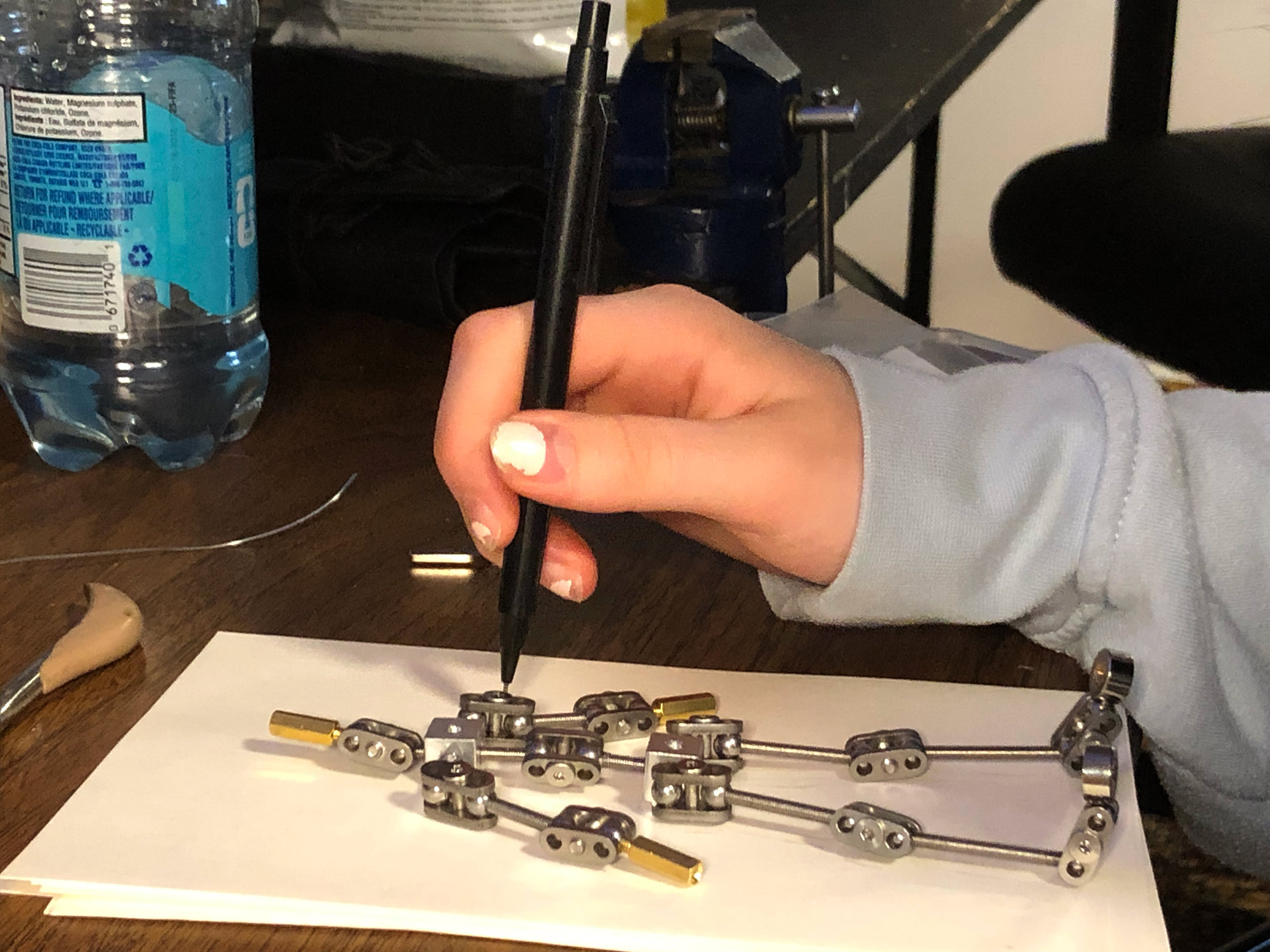 Animation student Marion assembling her new stop motion ball and socket armature project. Workshops by The Clayman Studio. The image captures the hands-on creative process of character design and animation production.